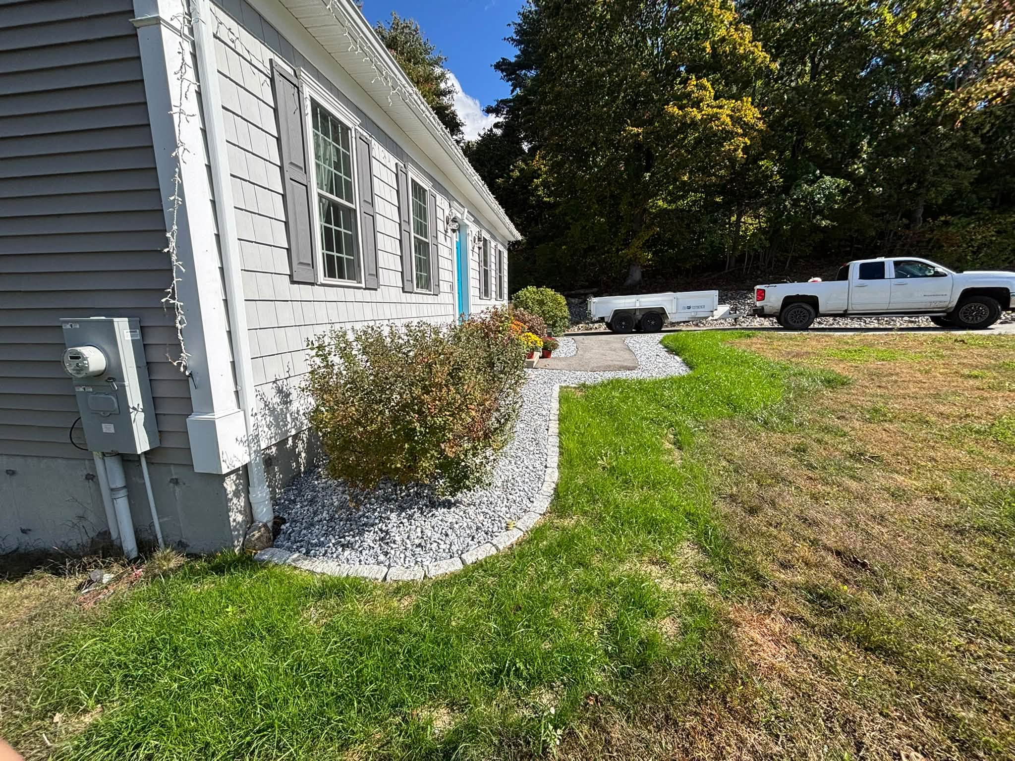 Lawn established alongside cobblestone border — Spencer, MA